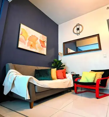 a living room with a couch and a mirror at Explore Mitsukoshi BGC with pool and wifi in Manila