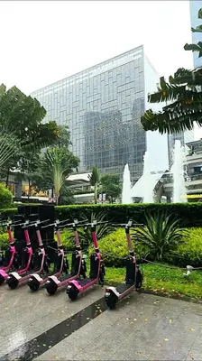 a row of exercise bikes parked in front of a building at Explore Mitsukoshi BGC with pool and wifi in Manila