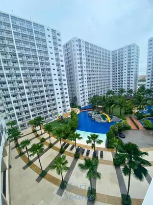 an aerial view of a resort with a pool and palm trees at Maria Solace in Manila