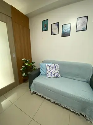 a room with a couch with a pillow on it at Maria Solace in Manila