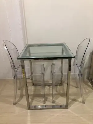 two chairs and a glass table with a glass top at 1 BR Taytay HIVE Condo WIFI Netflix Pool Patio in Taytay