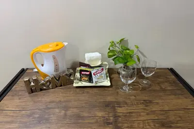 a table with a coffee maker and glasses on it at 81 Newport Boulevard across NAIA T3 Airport in Manila