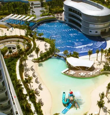 a pool at a resort with a water slide at Playa Delea Minimalist Azure 1BR Pool Beach Staycation in Manila