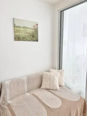 a bed in a white room with a window at Playa Delea Minimalist Azure 1BR Pool Beach Staycation in Manila