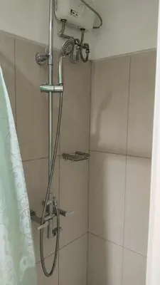 a shower with a shower head in a bathroom at Premiere Haven MOA Staycation in Manila