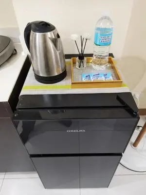 a counter with a coffee pot and a bottle of water at 25mins from NAIA1 in Manila