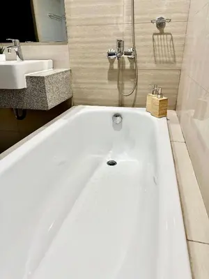 a white bath tub in a bathroom with a sink at Bayshore 2 ManilaBay Seaview 3 in Manila