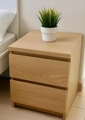a wooden bedside table with a potted plant on it at Bayshore 2 ManilaBay Seaview 3 in Manila