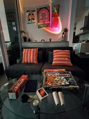 a living room with a couch and a glass table at Azure Staycation with Pool View, Wifi and Netflix in Manila