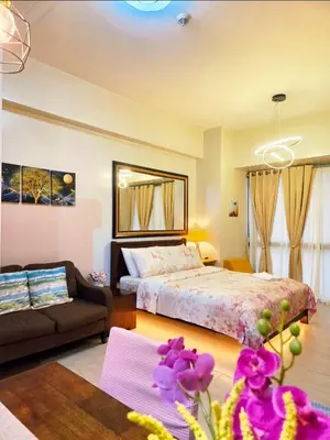 a bedroom with a bed and a couch in a room at Hauze of B&Y - 81 Newport Blvd across T3 in Manila