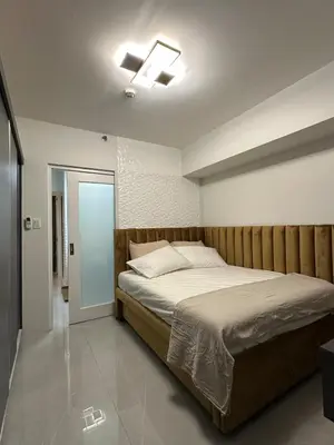 a bedroom with a bed and a ceiling fan at Resort-style oasis at the the heart of the city in Manila