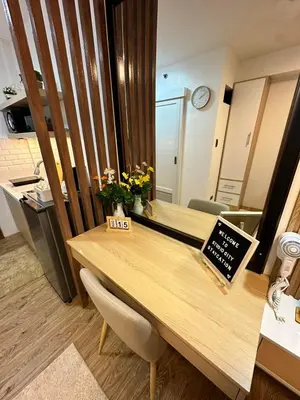a room with a wooden desk with a counter top at Studio City Staycation in Alabang in Manila
