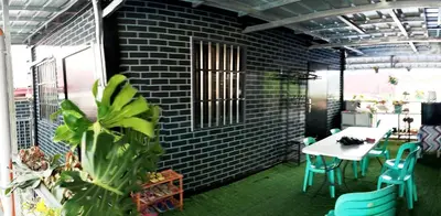 a patio with a table and chairs and a brick wall at 6 Guest - Unit 6 Studio type - Container house in Pasong Mannga