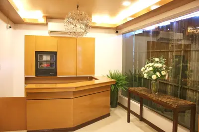 a kitchen with a counter and a vase of flowers at LuxeLite Suites Pasay in Pasay