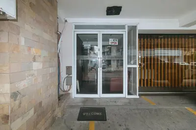 a sign in front of a door of a store at RedDoorz at Regina Hometel J Victor in Manila