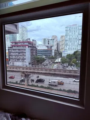 a view of a city from a window at Condotel in Manila