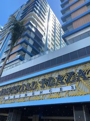 a sign on the side of a building with a palm tree at Condotel by Heidi in Manila