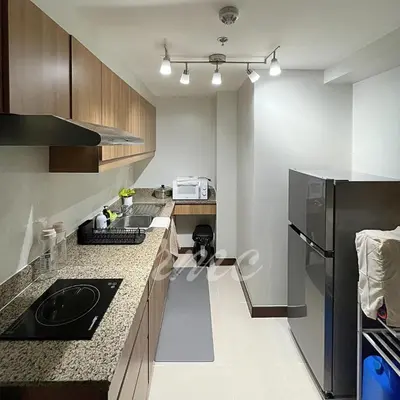 a kitchen with a sink and a refrigerator at A Space Close to Transits or Airport in Manila