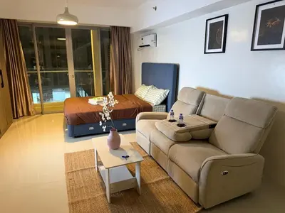 a living room with a couch and a bed at pocco homestay in Manila