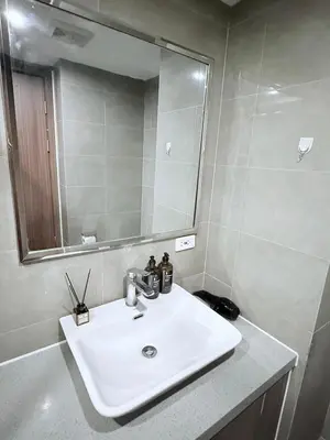 a bathroom with a white sink and a mirror at pocco homestay in Manila