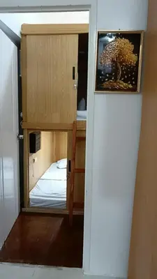 a room with a mirror and a bed in a room at Capsule88 Hotel in Manila