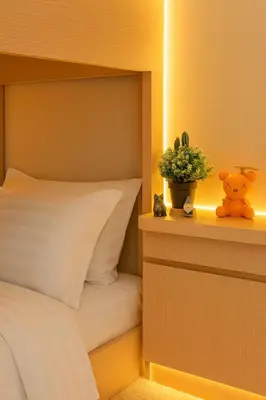 a bedroom with a bed and a potted plant on a shelf at Spacious 5-Bedroom Luxury Apartment Across Okada in Manila