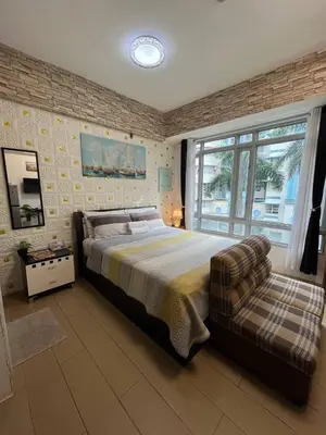 a bedroom with a large bed and a window at Marvinn's by LVH - 150 Newport Boulevard in Manila