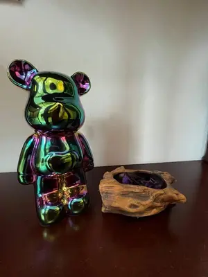 a green glass cat sitting on a table next to a bowl at Marvinn's by LVH - 150 Newport Boulevard in Manila