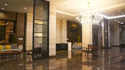 a lobby of a hotel with a chandelier at Manila Bay Condo in Manila
