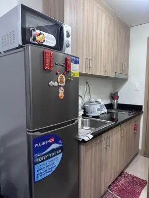 a kitchen with a black refrigerator and a sink at Amazing view in Shore 2 Residences by Richnells in Manila