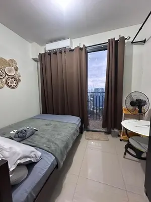 a bedroom with a bed and a window with a view at Amazing view in Shore 2 Residences by Richnells in Manila