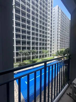 a balcony with a view of a large building at Shore 2 tower 1 by Richnells cozy Oasis in Manila