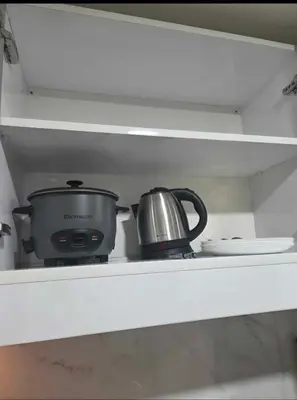 a pot sitting on top of a stove in a kitchen at Jazz Haven Makati in Manila