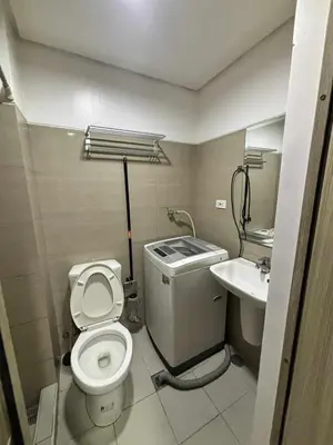 a small bathroom with a toilet and a sink at 3 single beds transient room mall of asia pasay in Manila