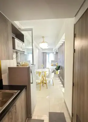 a kitchen with a table and a dining room at Sweet Escape at S Residences in Manila