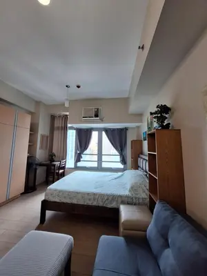 a bedroom with a bed and a couch at Eastwood Legrand3 Studio Type condo in Manila