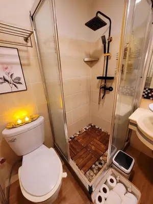 a bathroom with a shower and a toilet and a sink at Stunning Suite 10 Steps from Eastwood Mall in Manila