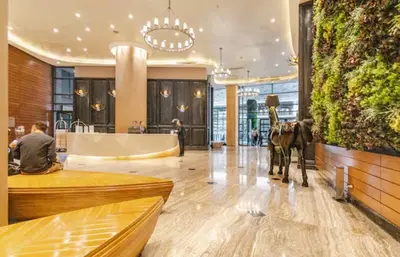 a restaurant with a horse statue in the middle of a lobby at Incredible Makati Studio Unit w Stunning view & 65 TV in Manila
