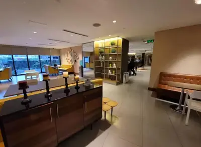 a lobby of a store with a counter and chairs at Incredible Makati Studio Unit w Stunning view & 65 TV in Manila