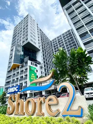 a store sign in front of a building at ClaySky Staycation at Shore 2 Residences Tower 2 near Mall of Asia- Hotel Set Up in Amenity and Pool Level with Netflix, HBO Max & Youtube Premium in Manila