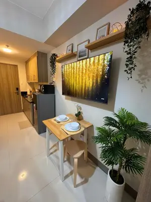 a kitchen with a table and a dining room at Newly-furnished 1BR with Balcony near MRT Mandaluyong in Manila