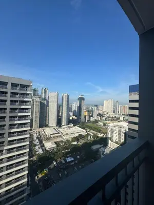 a view of a city from the balcony of a building at Newly-furnished 1BR with Balcony near MRT Mandaluyong in Manila