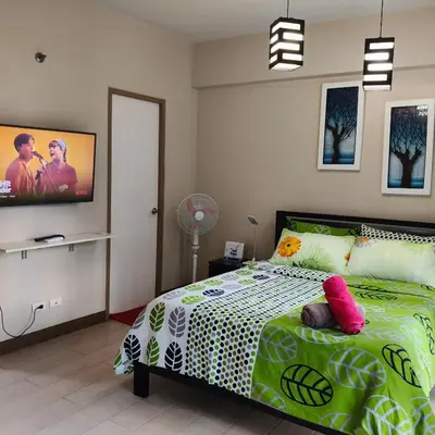 a bedroom with a bed and a tv on the wall at LDN Secret Crib 3P - Two Palm in Manila