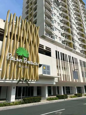 a building with a palm retrieval sign on it at Palm Beach West - Baler Tower in Manila