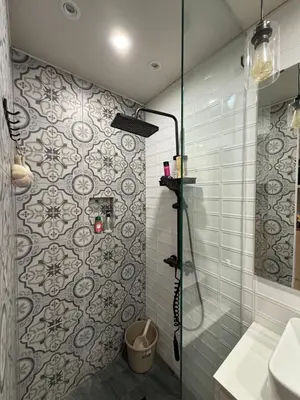 a bathroom with a shower with a glass door at Flat 316 Modern Minimalist Studio Near Makati BGC in Manila