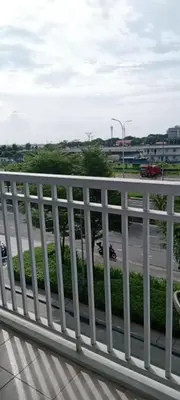 a white railing on a bridge with a street at Like home staycation in Manila