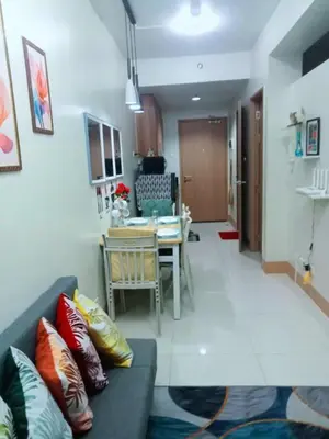 a living room with a couch and a table at Like home staycation in Manila