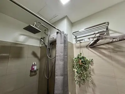 a bathroom with a shower with a shower curtain at Coffee Room 1666 Shore 2 Residences Tower 1 Pool View by Prime Stay MOA in Manila