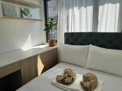 a room with a bed with two towels on it at 2BR facing Manila Bay & City View Shore 2 Residences MOA with Parking by Prime Stay in Manila