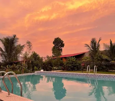 a swimming pool with a sunset in the background at Casa Ylaya - a New Private Pool Getaway in General Trias